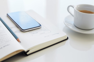 Wall Mural - pencil and mobile phone lying on an open diary