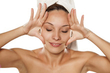Young Beautiful Woman Tightens Her Face With Her Hands.