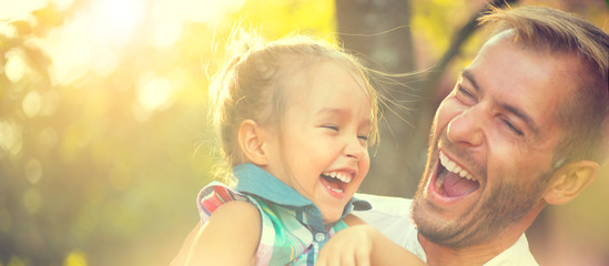 Happy joyful young father with his little daughter