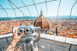 Top view from the bell tower with binocular on the dome of Santa Maria del Fiore church and old town in Florence
