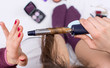 © creativefamily - Woman using curling iron on her hair