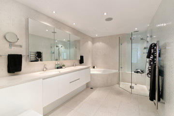 Stylish clean bathroom with shower and bath tub