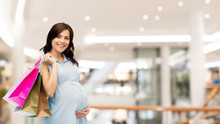 Happy Pregnant Woman With Shopping Bags