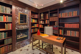 Fototapeta Dinusie - Amazing private Library with bookshelf, fire place and desk.