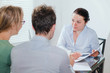 © Song_about_summer - consultant or real estate agent working with couple of customers in the office