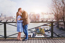 Romantic Date, Young Couple Kissing On The Bridge In Paris