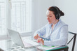 © Song_about_summer - business woman participating online video conference in the office