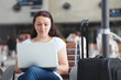 © Song_about_summer - woman with laptop in airport, using internet connection, traveler checking email