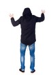 © ghoststone - Back view of man. Raised his fist up in victory sign. Rear view people collection. guy with a hood on his head while wearing someone scary.