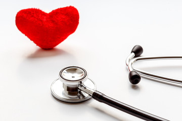 stethoscope on white background with plush heart