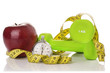 © sacura14 - Two dumbbells, red apple, measuring tape.