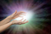 Beaming Color Healing Energy - Female Hands With A Ball Of White Light Emitting Rainbow Colored Light Outwards On A Dark Vignette Background And Copy Space Around