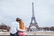 © Song_about_summer - romantic couple looking at Eiffel tower in Paris, honeymoon background