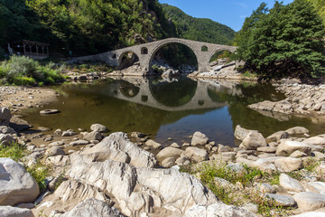 Reflection of Devil's Bridge and Rhodopes mountain in Arda river, Kardzhali Region, Bulgaria 