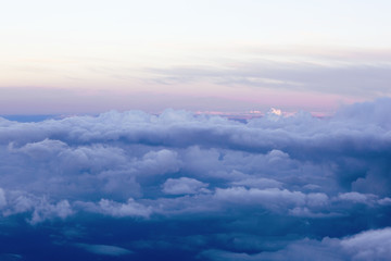 Wall Mural - Fluffy clouds over the earth, the landscape. The scenic sky during sunset, the view from the air. 