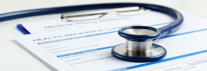 stethoscope on health insurance form