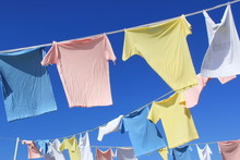 T-shirts Hanging On Rope In Front Of Blue Sky