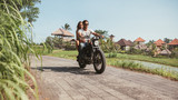 Fototapeta  - Young couple riding motorcycle on rural road