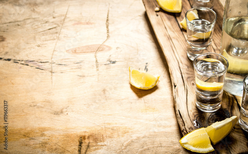 фотографія  Vodka in shot glasses with lemon.