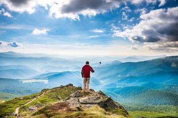 Young man on mountain taking selfie