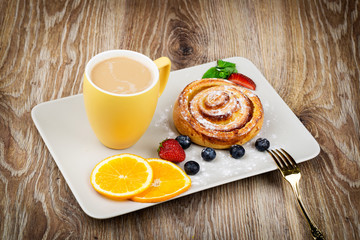 Wall Mural - Cup of coffee and pastry on wooden background