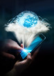© sdecoret - Digital world in a cloud connected to businesswoman mobile phone