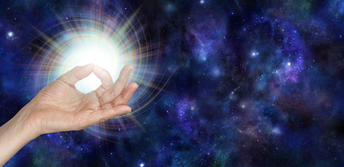 Wall Mural - Gyan Mudra and the Spark of Life - female hand with thumb and index finger touching giving out a bright vortexing spark on a dark blue deep space background with copy space to the right