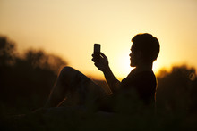 Silhouette Of One Man Taking Picture In The Sunset Outdoor. 