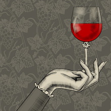 Women's Hand With A Wine Glass On Grapes Background