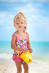 girl two years old in a bright swimsuit