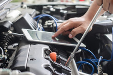 Hands Of Car Mechanic In Auto Repair Service.