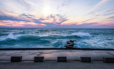 Wall Mural - Waves And Lake Michigan Sunset. The sunset over the coast of the Lake Michigan horizon during a gale warning. Lake Michigan is the third largest of the Great Lakes.