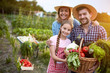 © luckybusiness - Satisfied farmers family with organic vegetables