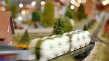 Model Trains Meet And Cross On A Diorama
