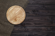 Round Cutting Board On Dark Wooden Table