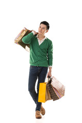 Wall Mural - Asian young man holding shopping bags