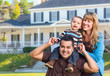 © Andy Dean - Happy Mixed Race Young Family in Front of House
