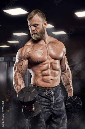 Fotografie, Obraz Muscular athletic bodybuilder fitness model posing after exercises in gym