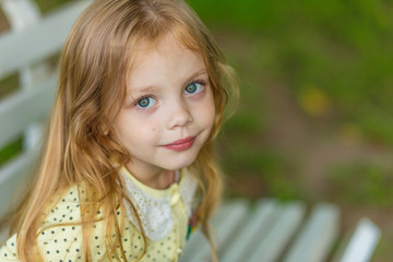 Portrait of a cute girl with long blond hair