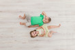 © Nadin Kolobova - Little boy and girl lying on the floor.