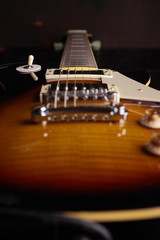 Old electric guitar on wooden table and background