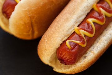 Wall Mural - Barbecue Grilled Hot Dog with Yellow Mustard and ketchup on wooden table. Fast food.