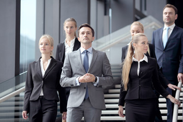 Business people standing on stairs