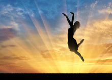 Happy Woman Jumping At Sunset