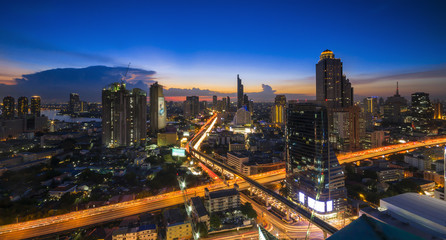 Bangkok Transportation at Dusk with Modern Business Building along the river (Thailand)