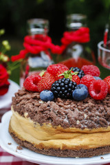 Wall Mural - Cheesecake with chocolate topping decorated with summer fruits