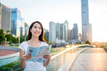 Wall Mural - Woman searching location on paper map