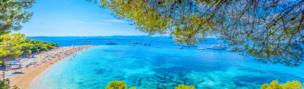 Famous adriatic beach panorama. / Famous adriatic beach Golden Horn (Zlatni Rat) in Bol, Island of Brac, Croatia summertime panorama. - obrazy, fototapety, plakaty 