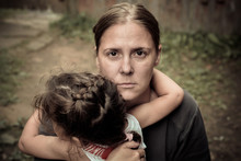 A Woman Holds A Child, Trying To Calm Him Down. The Child Is Three Years.
