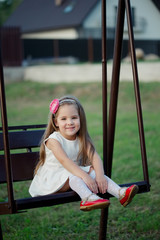 Wall Mural - happy girl on the swings